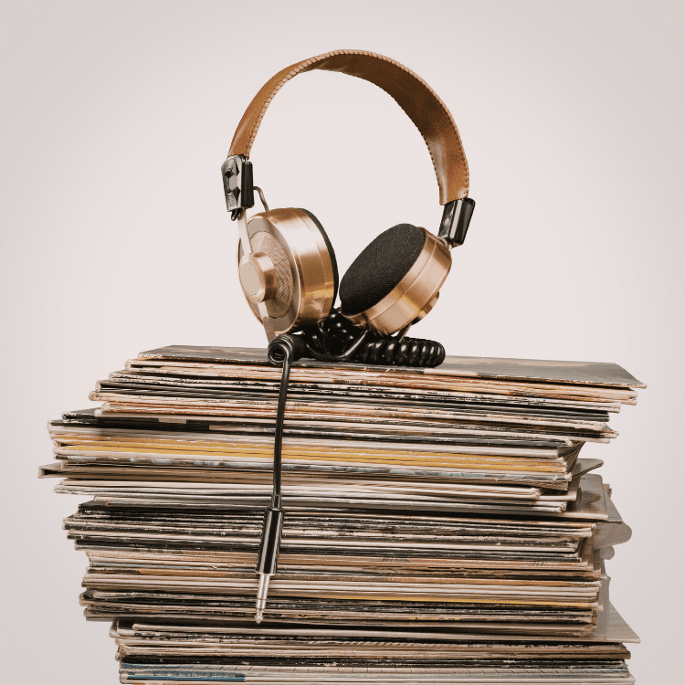 Headphones on top of a rack of records. This is linked to the article's topic. Symbolizes starting a record label from your bedroom where you can find those items 