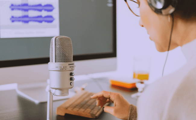 Person recording music, organizing and scaling their business from their bedroom. Staring a record label from home