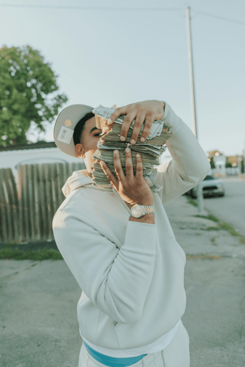 independent music artist flexing jhis money and his watch. the watch represents a long lasting record label 