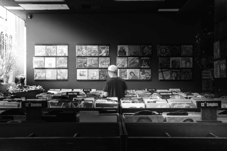 independent music artist who has never signed to a label and in a record store looking at the labels 