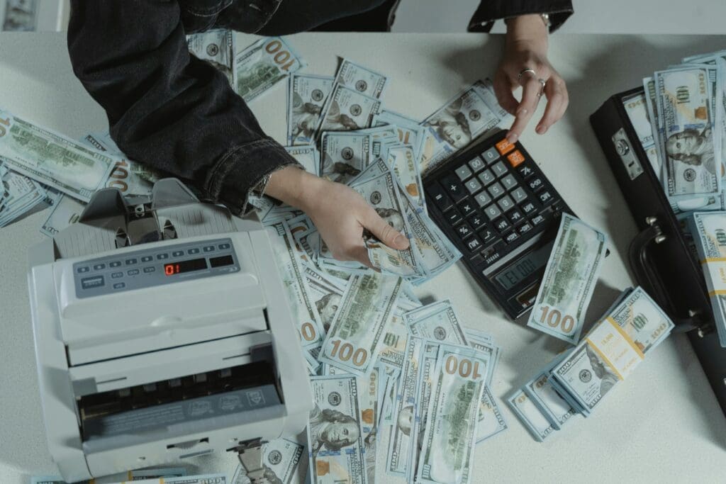 Person budgeting the cost of starting an new record label as an independant artist. counting big amounts of money they made. 